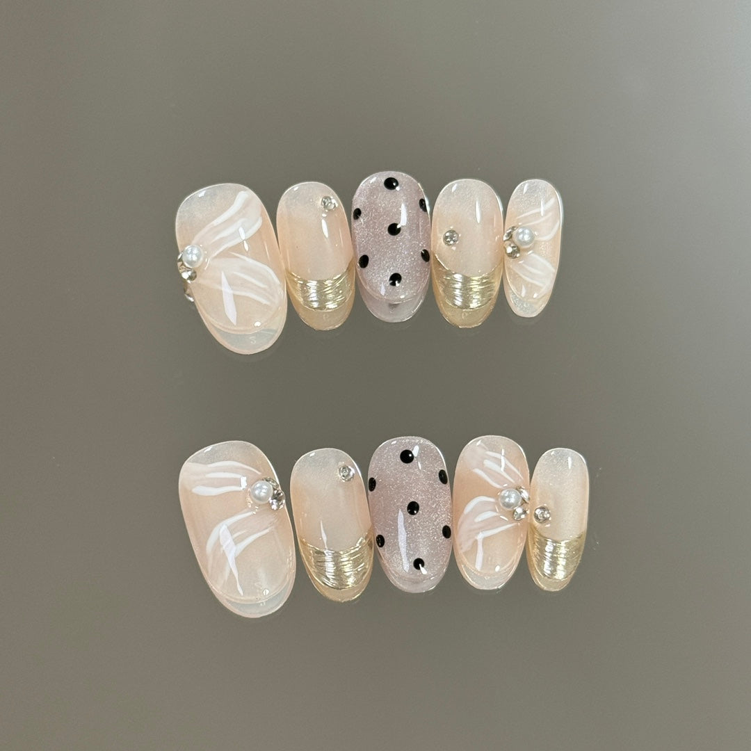 2. "AdhesiveBacked Nude Pink Press On Nails Featuring Elegant Begonia Polka Dots"