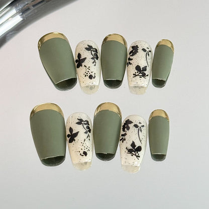 1. Fallinspired leaf pattern presson nails with gold accents for a chic autumn look.