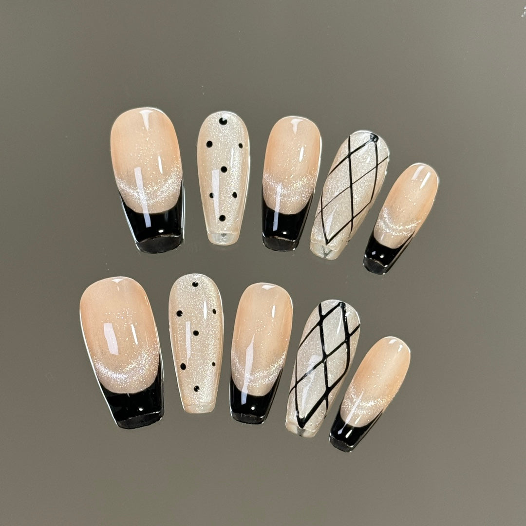 3. Stylish black presson nails with a modern twist, adorned with glittering polka dots.