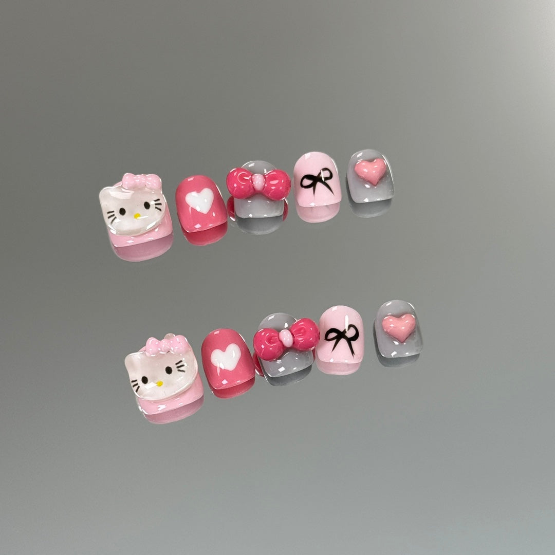 1. "Glossy Hello Kitty Bow Chrome PressOn Nails for Short and Round Nail Shapes"