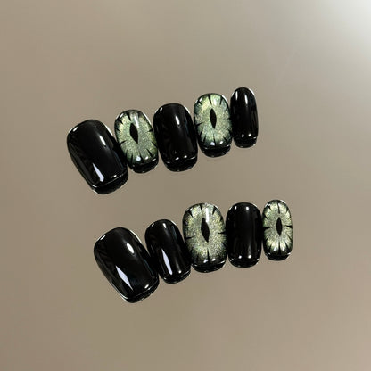 1. Elegant black glitter presson nails for a chic Halloween look.