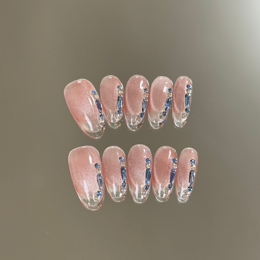 1. Chic almondshaped cat eye presson nails with hot pink accents for a bold fashion statement.