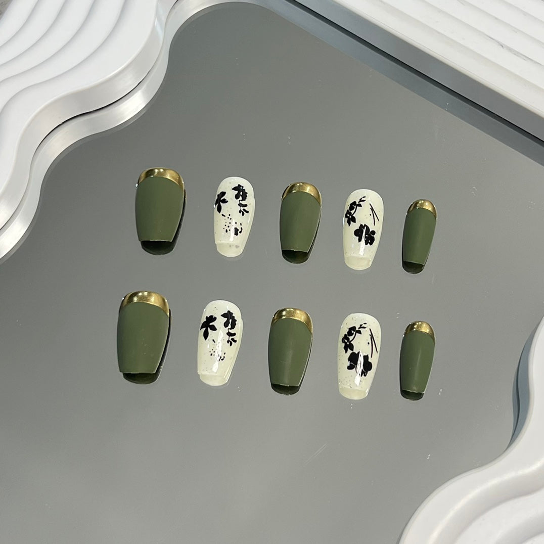 4. Vibrant green French tip nails with autumn leaf art and gold border for a stylish upgrade.