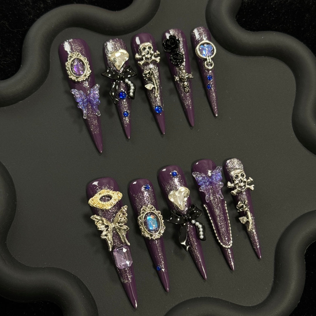 2. Reusable gothic stiletto nails featuring a dark purple base and black butterfly design for a chic Halloween vibe.