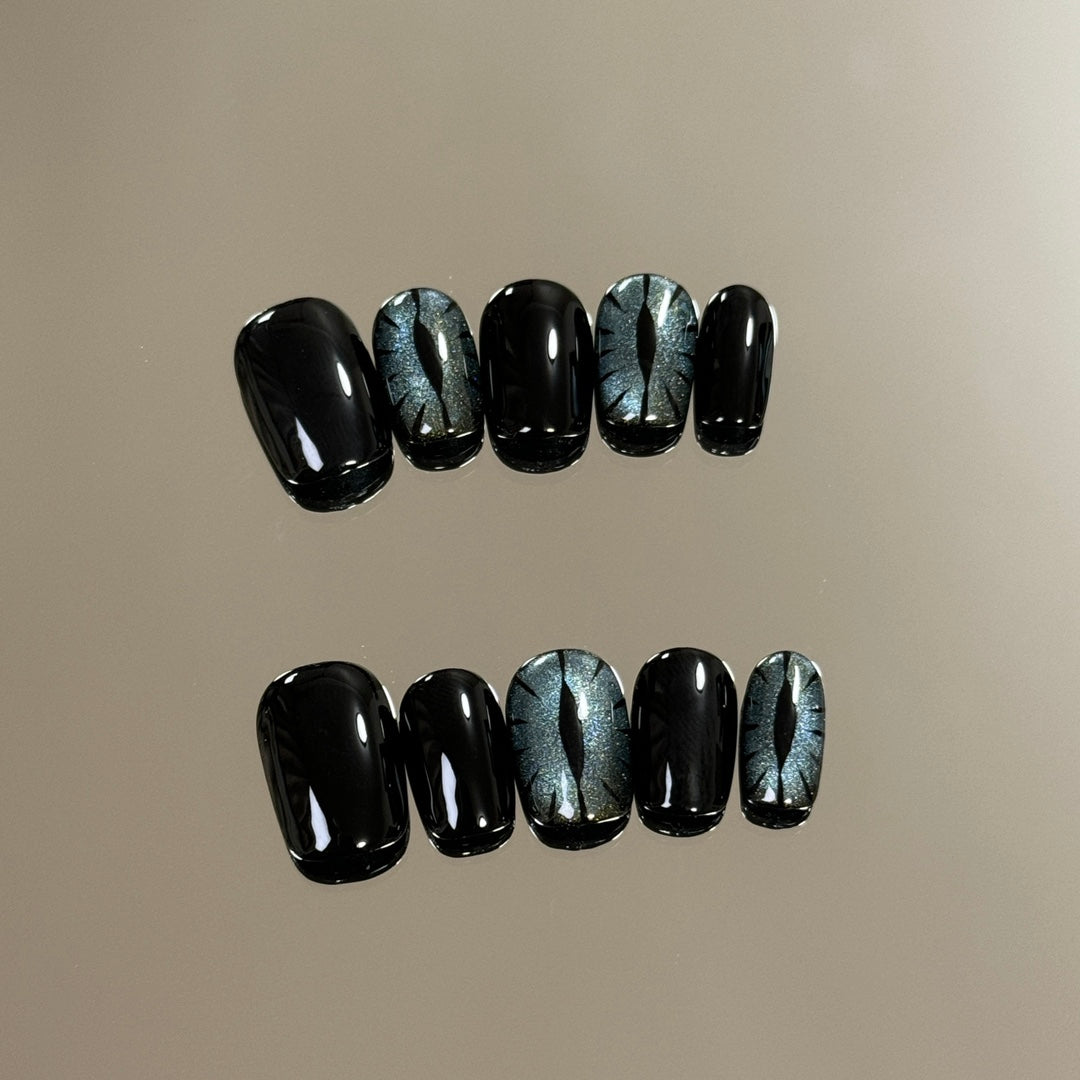 2. "Short Round Black Glitter Cat Eye Nails for Quick and Easy Halloween Styling"