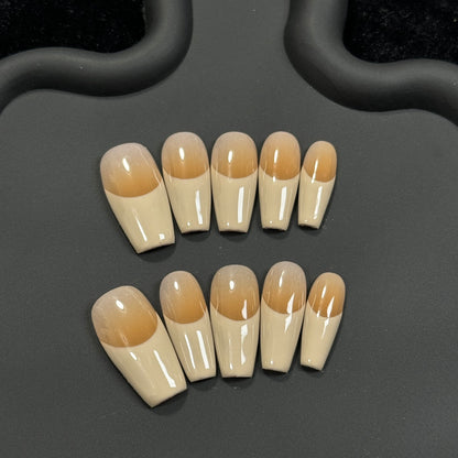 1. Khaki medium coffin nails with a glossy ombre french tip design for a chic and sophisticated look.