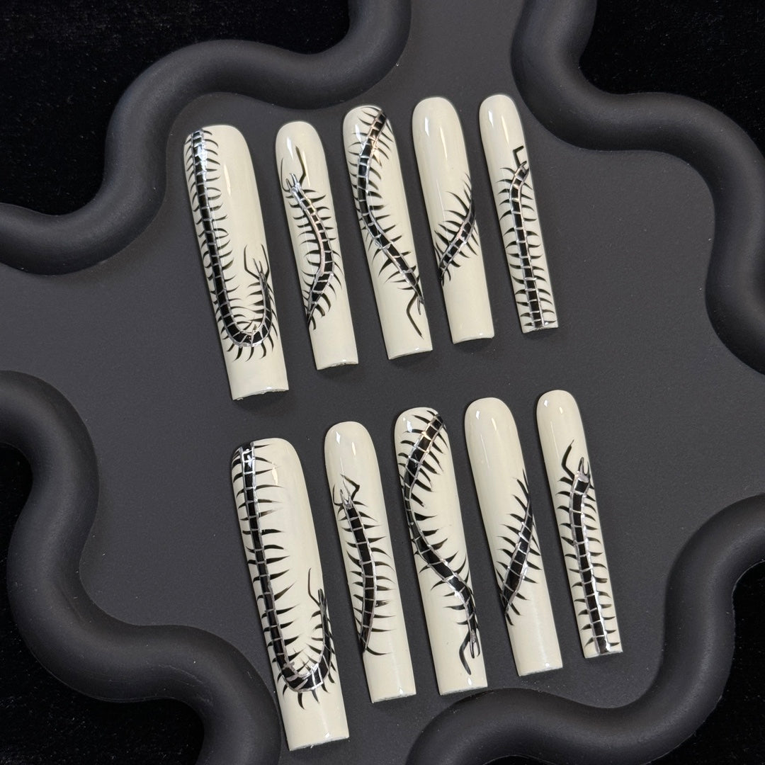 1. Timeless black and white centipede pattern presson nails, perfect for chic nail art enthusiasts.