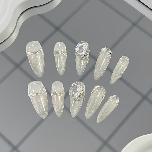 1. Elegant medium almondshaped presson nails with a dazzling white and silver cat eye ombre effect for weddings.