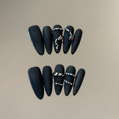 2. Stylish frosted snake skin pattern on black chrome presson nails for a modern fashion statement.