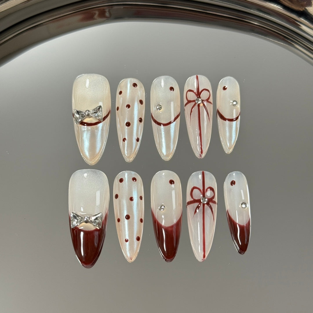 2. Luna white presson nails featuring a medium length and a stylish almond shape, ideal for a timeless fashion statement.