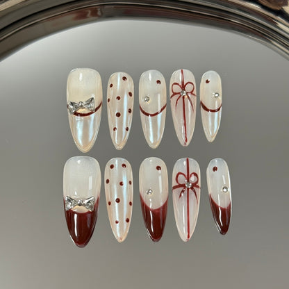 2. Luna white presson nails featuring a medium length and a stylish almond shape, ideal for a timeless fashion statement.