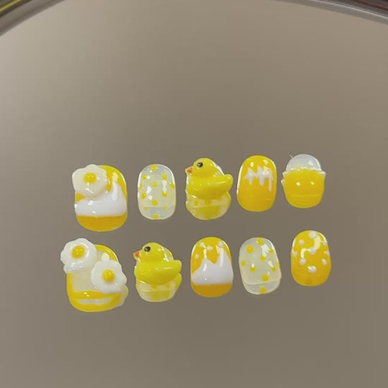 3. Safe and secure nail adhesive for fake nails, designed for short and round nail shapes in a cheerful yellow.