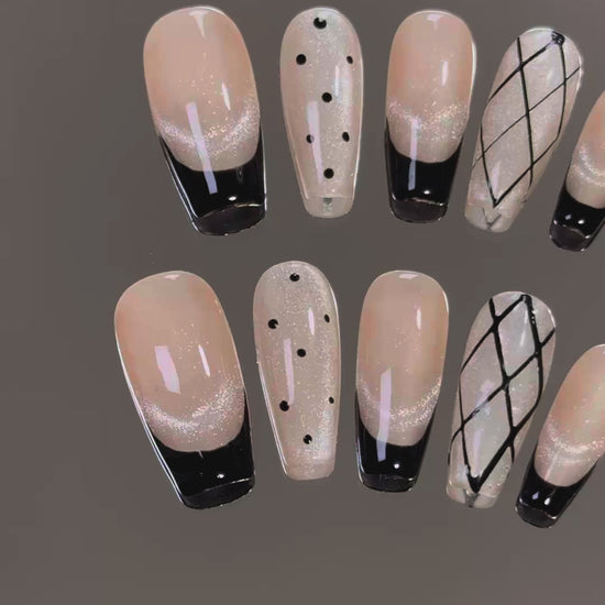 4. Elegant and edgy black coffin nails with a touch of glitter for a glamorous finish.