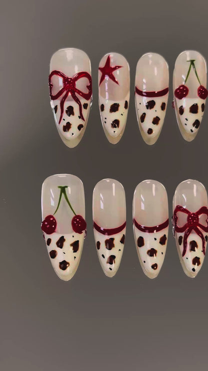 3. "Elegant almondshaped presson nails with a glossy leopard print and cherry red tips for a sophisticated touch."