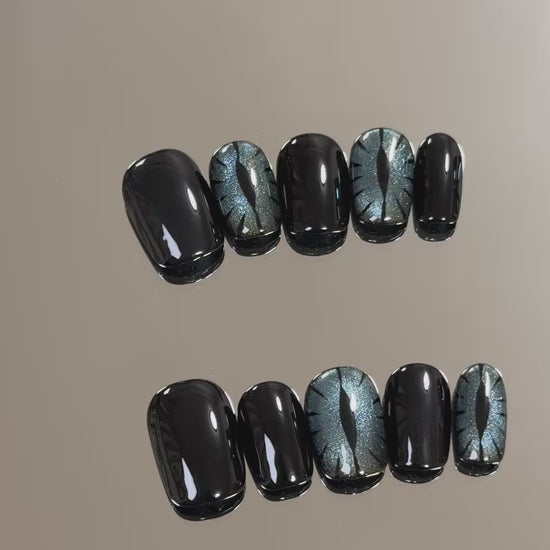 3. "Stylish Halloween Cat Eye Nails with Black Glitter for a Lasting Impression"