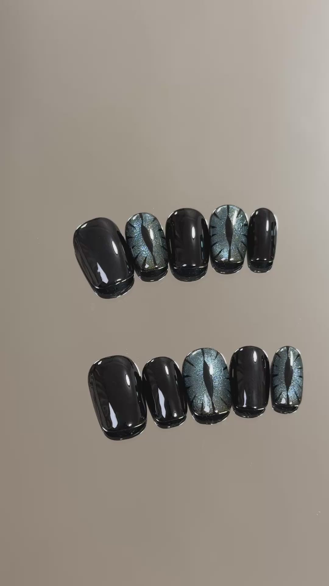 3. "Stylish Halloween Cat Eye Nails with Black Glitter for a Lasting Impression"