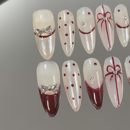 3. Elegantly designed presson nails in a medium almond shape, accentuated with a trendy French tip for a festive Christmas vibe.