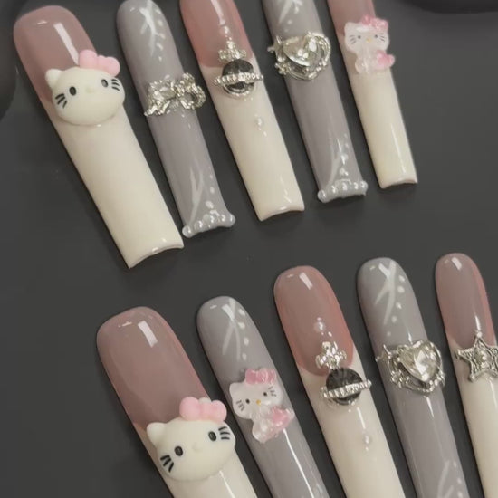 2. "Stylish Hello Kitty Brown & White Acrylic Nails, Perfect for FashionForward Looks"